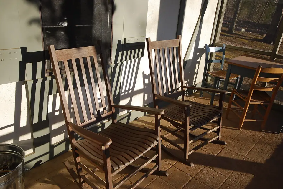 Rocking chairs on a screened porch deck