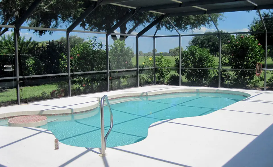 Screened pool enclosure over a Florida backyard pool