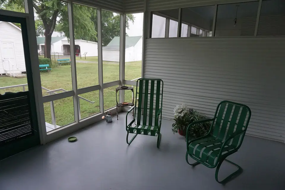 Inside a screened porch with two chairs